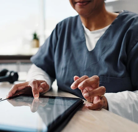 Healthcare professional using a tablet in a medical setting