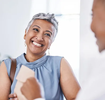 A senior woman smiling warmly during a conversation